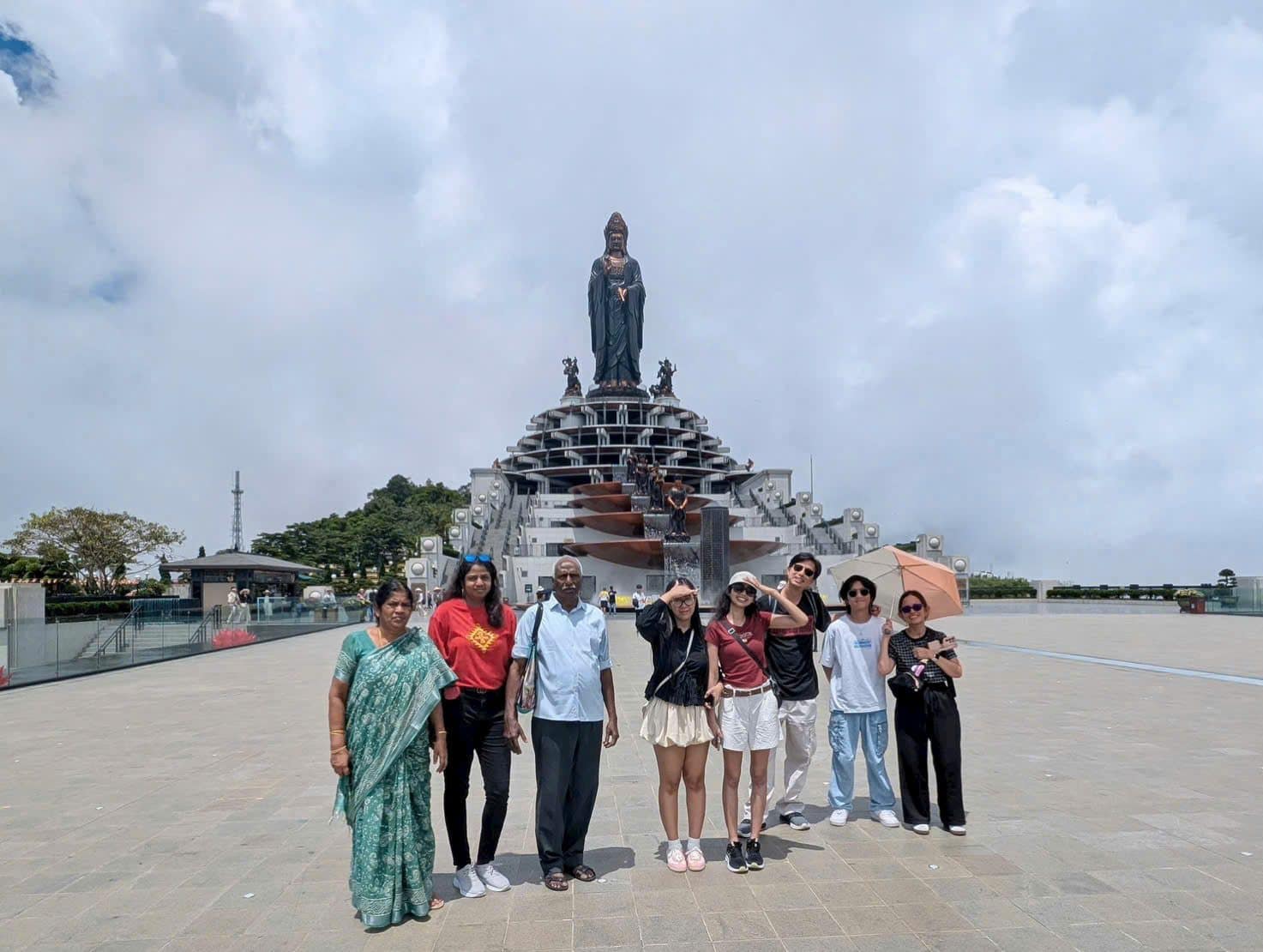 Guests on the plaza below the great bronze Buddha at the summit