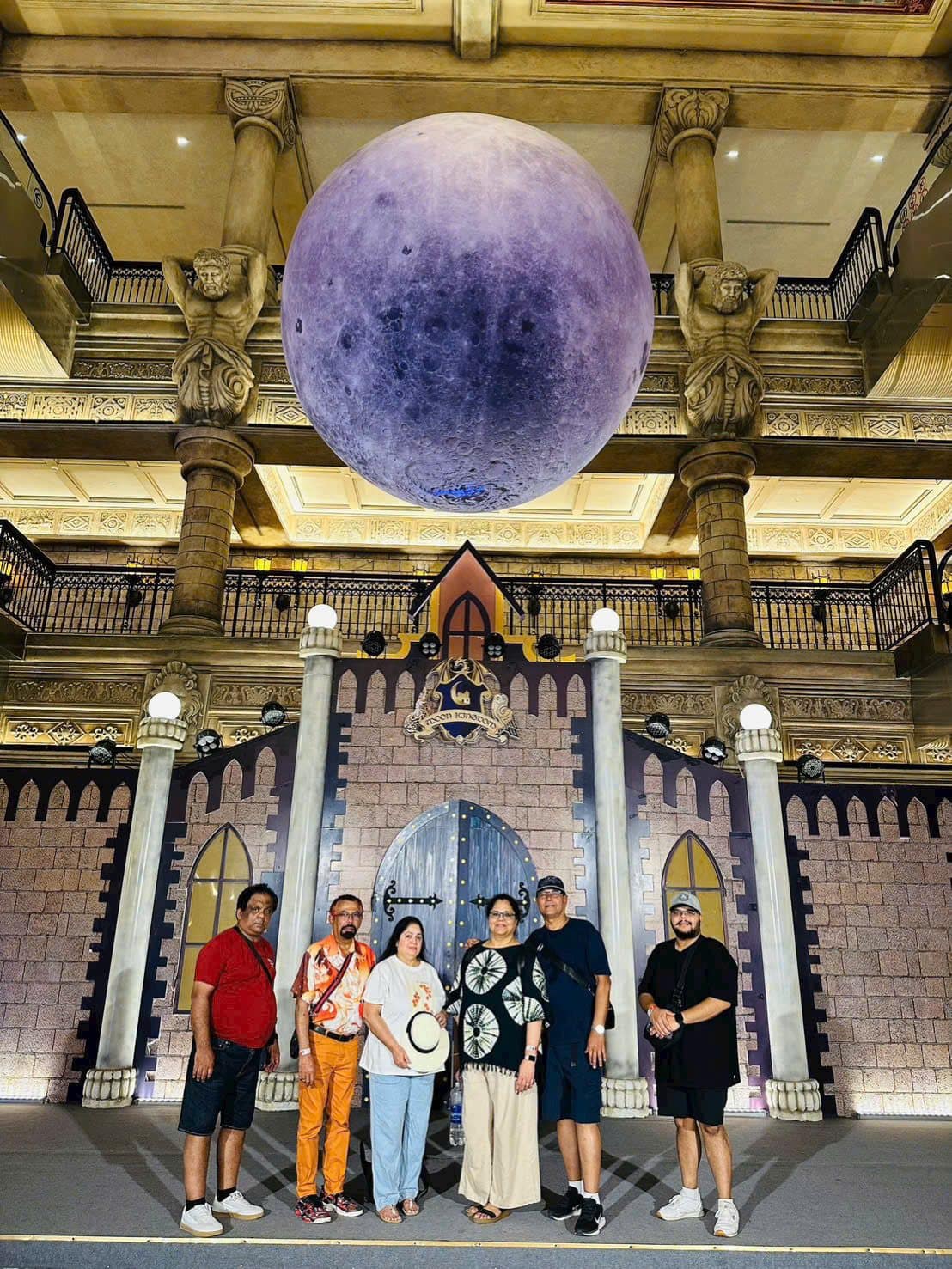 Guests under the suspended moon in the French Village hall at Ba Na Hills