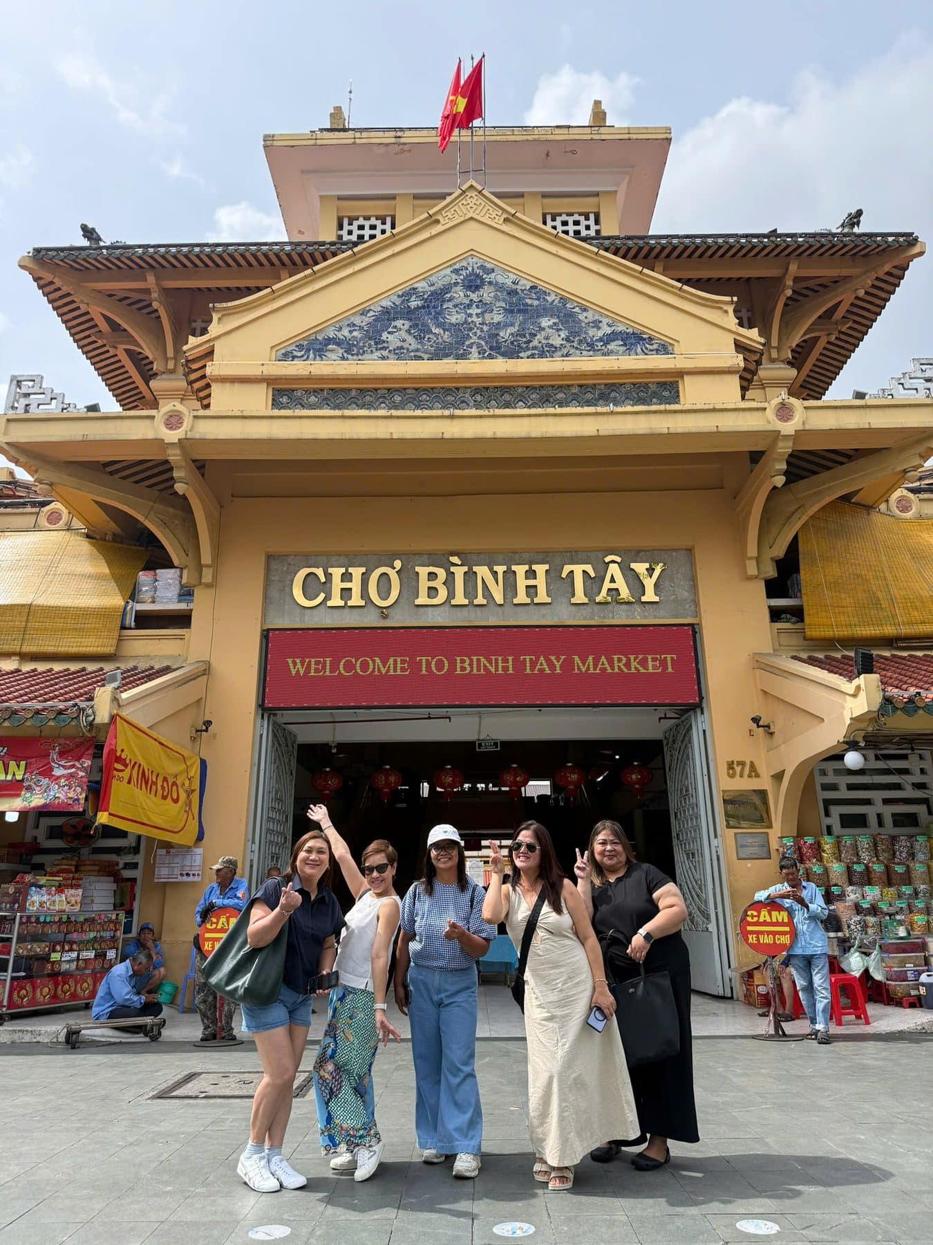 Guests at the yellow gate of Binh Tay Market in Cholon