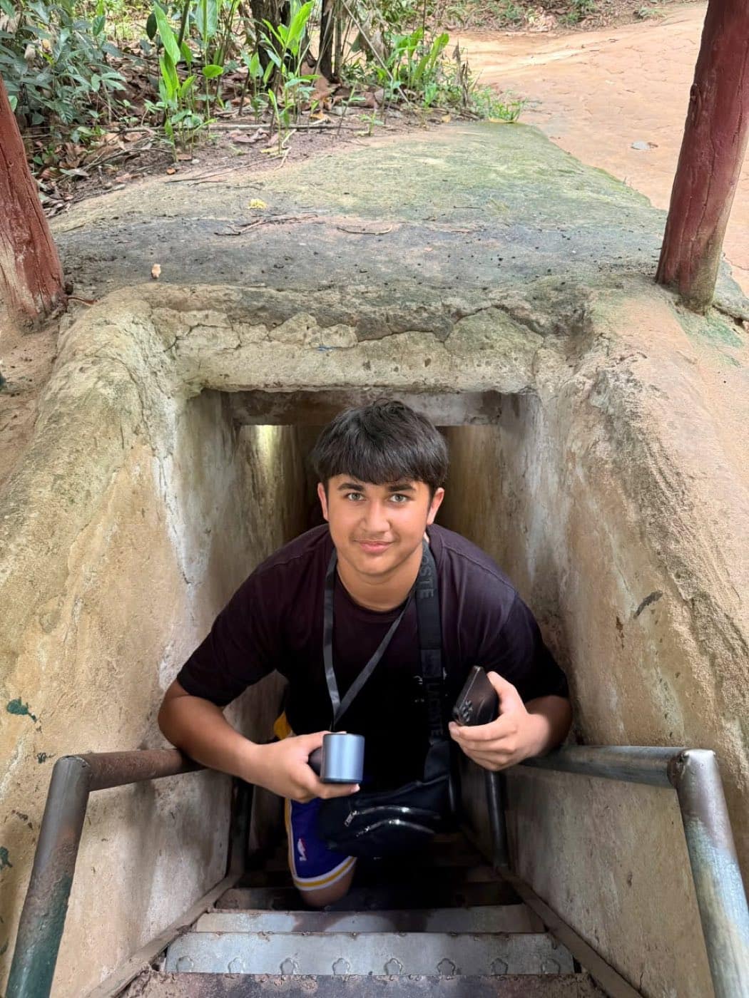 A guest on the concrete steps down into one of the tunnel entrances