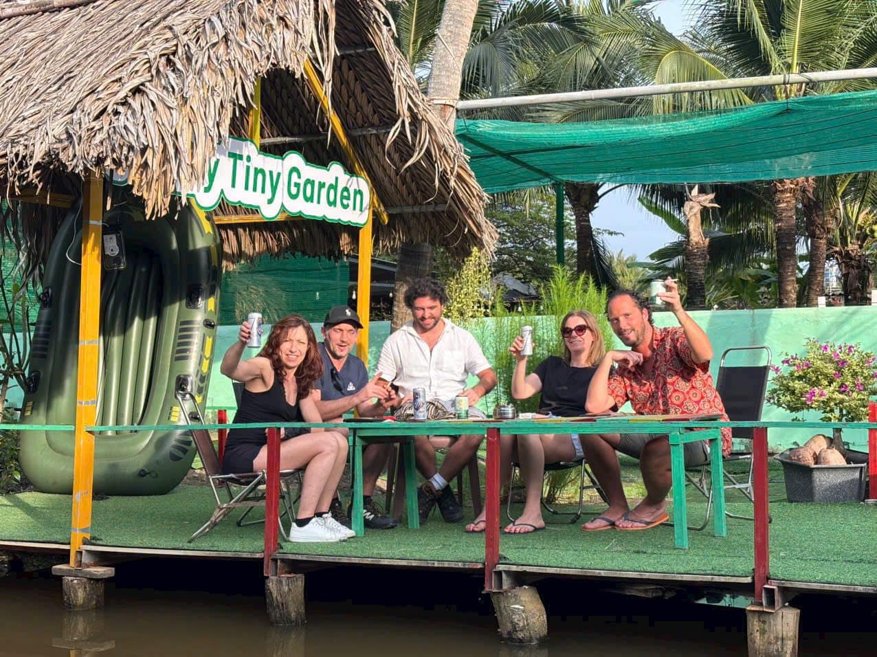 Guests with cold drinks on the deck of a garden cafe in the delta