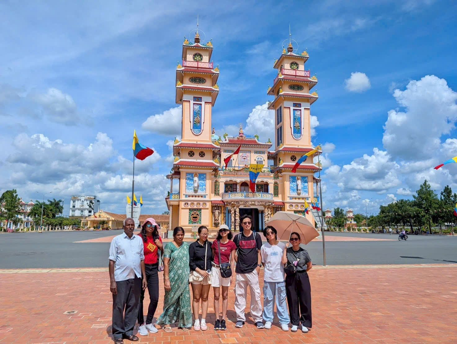 A group in front of the twin towers of the Cao Dai Holy See