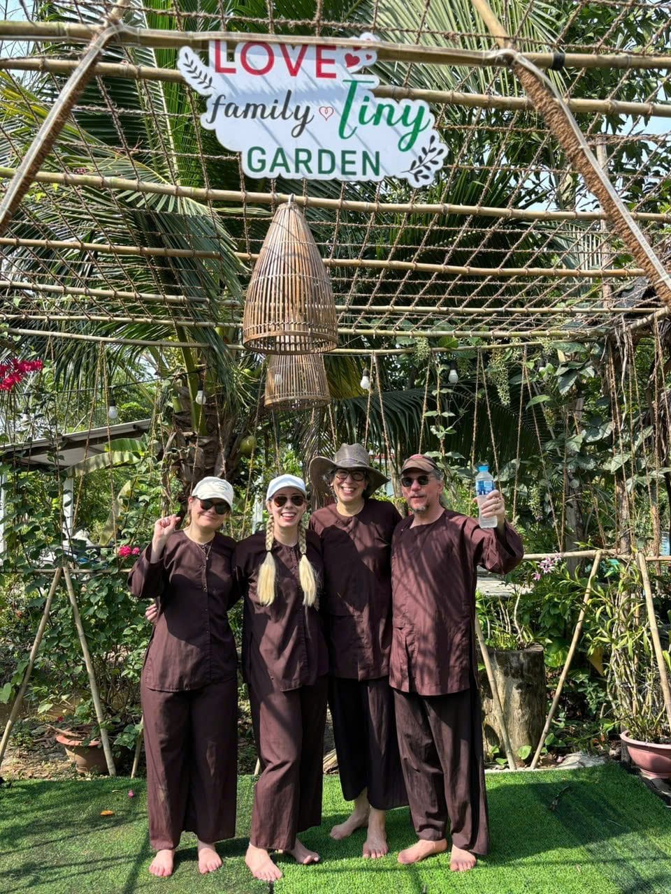 A group in brown ao ba ba at the garden arch before the farming morning